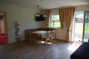 a dining room with a table and chairs at Appartement Tauernhof in Kleinarl