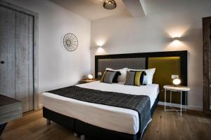 a bedroom with a large bed in a room at Teku Sardinia Boutique Hotel in Bari Sardo