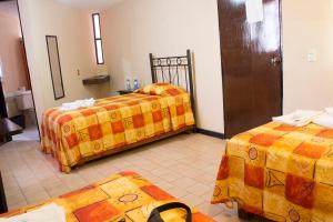 Ένα ή περισσότερα κρεβάτια σε δωμάτιο στο Villas Hotel Cholula