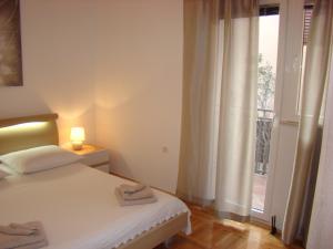 Postel nebo postele na pokoji v ubytování Apartments Ledic