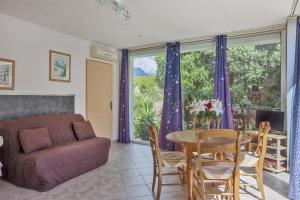 a living room with a table and a couch at Gites Carolina in Sisco