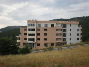 a large building on the side of a road at Вихрен-стаи и апартаменти за гости in Sandanski