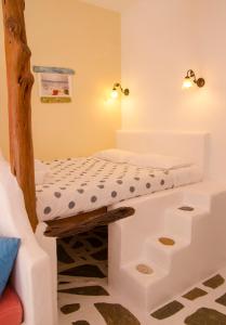a bedroom with a bunk bed and a couch at Lakki Village in Aegiali