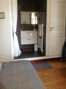 a room with a bathroom with a sink and a door at Villa Chanteraine in Fleury