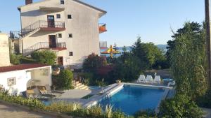 a house with a swimming pool next to a building at Apartment Katica in Crikvenica