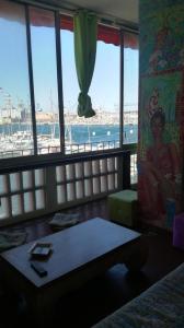 a room with a view of a marina from a bedroom at Palais Cronstadt in Toulon