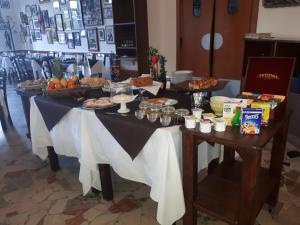 a table filled with plates of food and drinks at Hotel Il Pirata in Cinisi