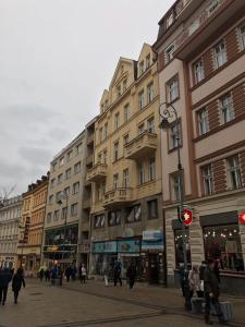 a group of buildings on a city street with people at Royal apartment in Karlovy Vary