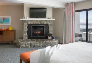 a living room with a fireplace and a bed at Dream Inn Santa Cruz in Santa Cruz