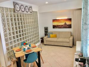 a living room with a table and a couch at Apartment Amadeus in Rome