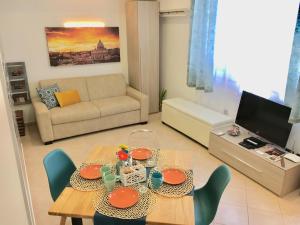 a living room with a table and a couch at Apartment Amadeus in Rome