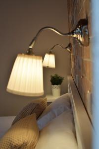 a bedroom with a bed with a lamp on a wall at The Coast in Anaxos