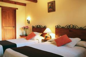 Postel nebo postele na pokoji v ubytování Hotel Posada Real Tapalpa