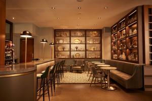 a bar with chairs and tables in a restaurant at Le Germain Hotel Toronto in Toronto