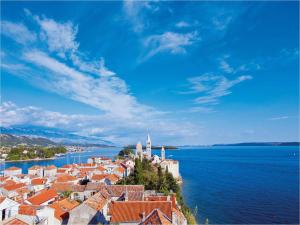 a view of a town on a hill next to the water at Paradise apartment - Old town Rab in Rab