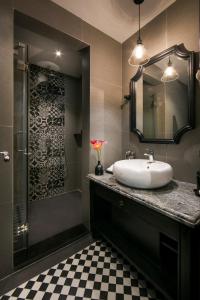 a bathroom with a sink and a shower at JM Marvel Hotel & Spa in Hanoi