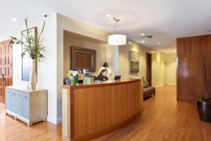 a woman sitting at a reception desk in a hotel lobby at Waters Edge in Tiburon