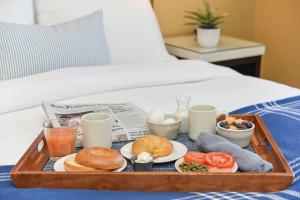 a tray of breakfast foods on a bed at Waters Edge in Tiburon +19 photos