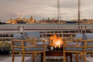 a fire pit on a balcony with a view of the city at Waters Edge in Tiburon