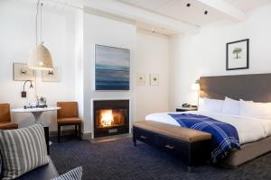 a bedroom with a bed and a fireplace at Waters Edge in Tiburon