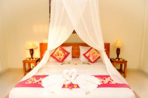a bedroom with a bed with a canopy at Semujan Bungalow in Ubud