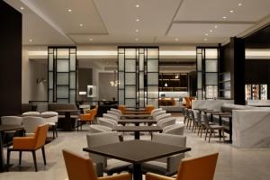 a restaurant with tables and chairs and a bar at Hyatt Place Shanghai Tianshan Plaza in Shanghai