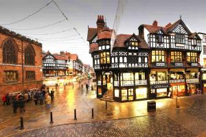 a group of buildings on a city street with people at The Townhouse Chester in Chester