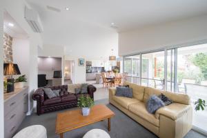 a living room with two couches and a table at Armidale Cottage on Barney - House 2 in Armidale