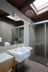 a bathroom with a sink and a shower at Chris's Beacon Point Restaurant & Villas in Apollo Bay
