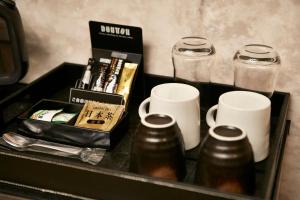 a tray with coffee mugs and a box on a table at WA HOTEL TIMELESS RESORT - Adult Only in Wakayama