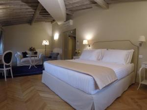 a bedroom with a large bed and a living room at Palazzo della Stufa Residenza D'Epoca in Florence
