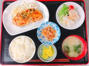 a tray of food with rice and different types of food at Hotel Tetora Hachinohe in Hachinohe