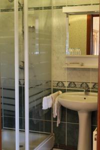 a bathroom with a sink and a shower at La ferme de la vallée in Auchy-au-Bois