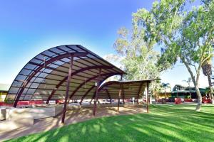 a pavilion in a park with trees and grass at Mercure Alice Springs Resort in Alice Springs