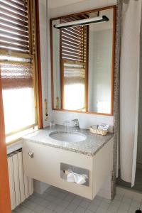 a bathroom with a sink and a mirror at Hotel Napoleon in Rimini