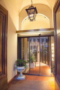 a lobby with a glass door with a vase at Hotel Palazzo Benci in Florence