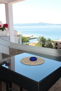 a table on a balcony with a view of the ocean at Ivan&Anka Selce apartments in Selce