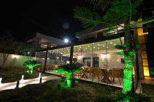 a building with a table and chairs at night at Dalyan Risus Suite in Çeşme