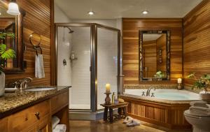 a bathroom with a tub and a toilet and a sink at The Whiteface Lodge in Lake Placid