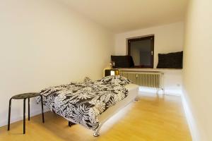 a bedroom with a bed and a mirror and a stool at Villa im Reiterdorf in Beverstedt