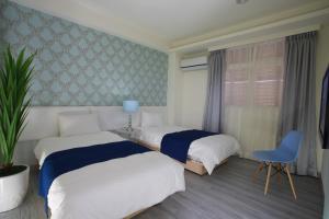 Postel nebo postele na pokoji v ubytování Guo Chen Hotel