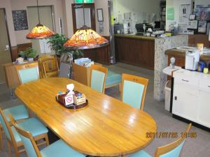 a dining room with a wooden table and chairs at Hotel Viva Nikko in Nikko +13 photos