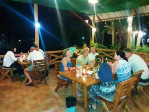a group of people sitting at tables in a restaurant at Huan Chiang Dao Resort in Chiang Dao
