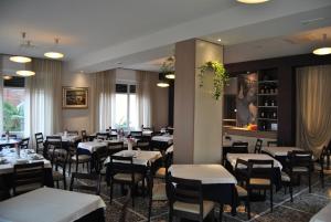 ein Restaurant mit Tischen und Stühlen in einem Raum in der Unterkunft Hotel Villa Mon Toc in Stresa
