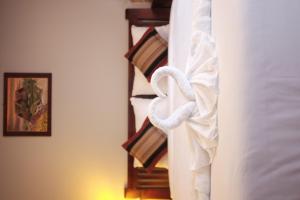 a hotel room with a bed with a white towel at Paradise riverview resort in Don Det