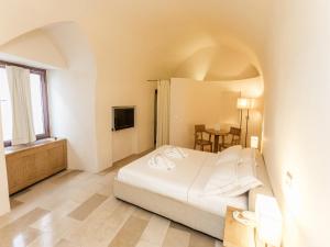 Кровать или кровати в номере La Sommità Relais & Chateaux