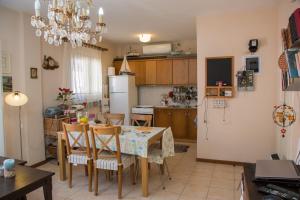 a kitchen and dining room with a table and chairs at Corfu Retreat in Corfu