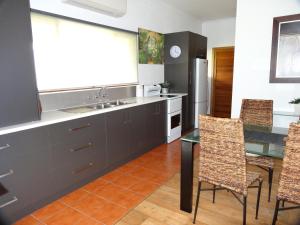 a kitchen with a sink and a table and chairs at Mapperley Bed and Breakfast in Bordertown