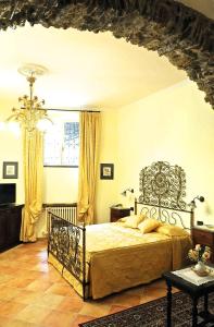 a bedroom with a bed and a chandelier at Il Giardino Incantato in Monterosso al Mare