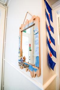 a mirror with a wooden frame on a wall at Eastbourne Reymar in Eastbourne